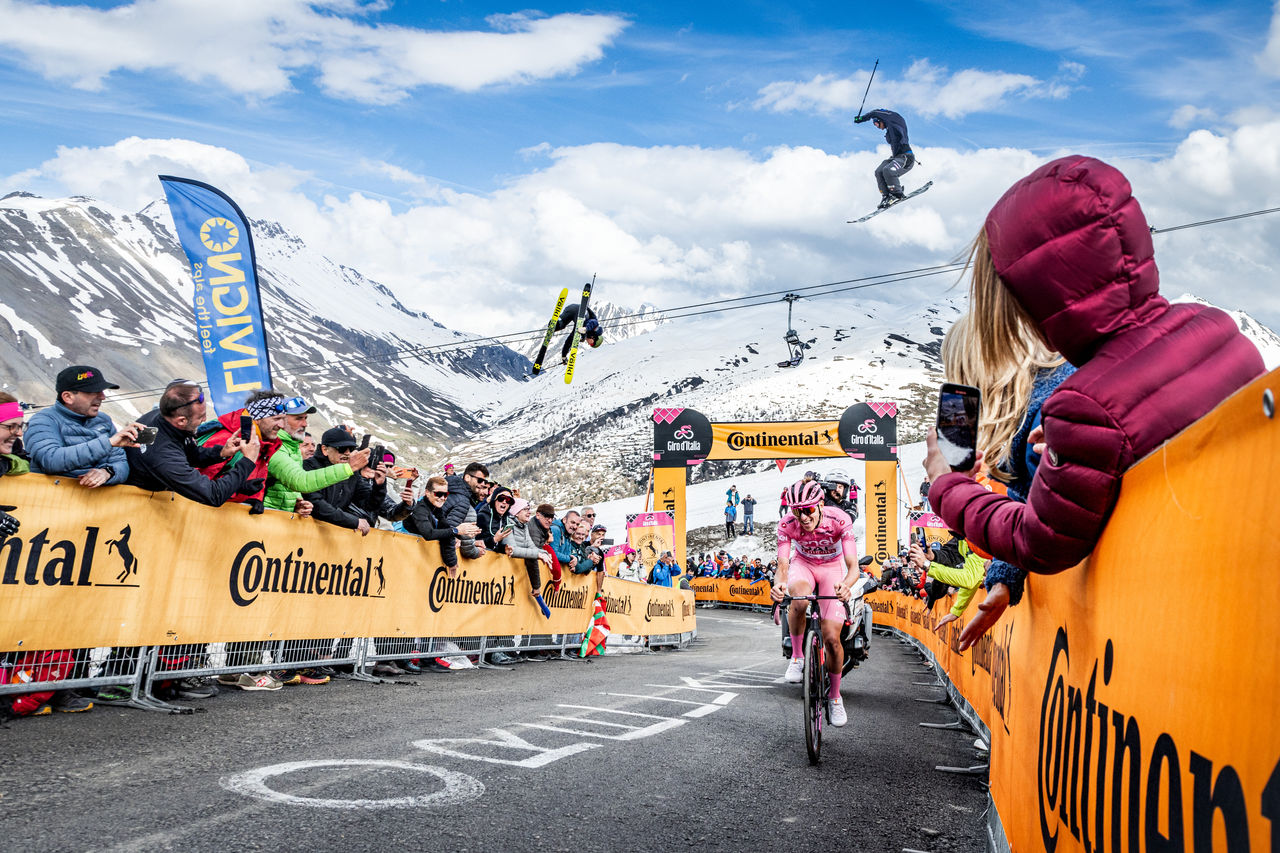 Skiers flying over cyclists during Giro d'Italia
